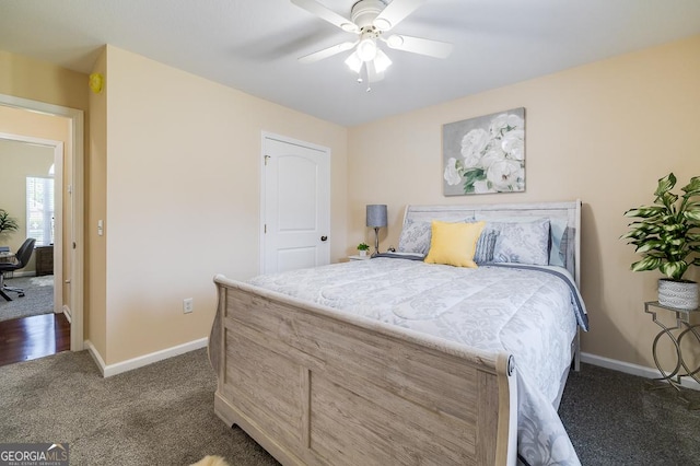 bedroom featuring baseboards, dark colored carpet, and ceiling fan