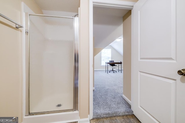 full bathroom with baseboards and a shower stall