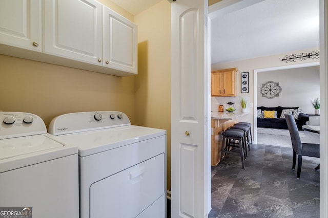 laundry room with cabinet space and washer and clothes dryer