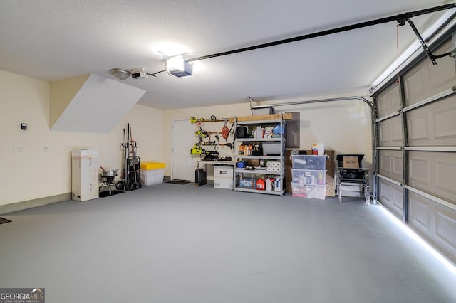 garage featuring electric panel and a garage door opener
