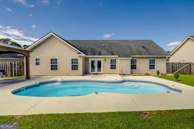 pool featuring a patio, french doors, and fence