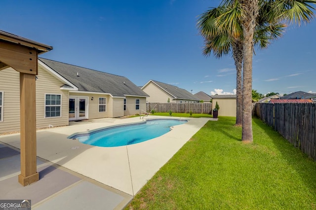 view of pool featuring a fenced in pool, a patio area, a lawn, french doors, and a fenced backyard