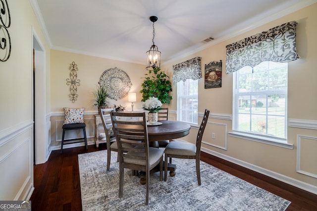 dining space with dark wood-style flooring, visible vents, and ornamental molding