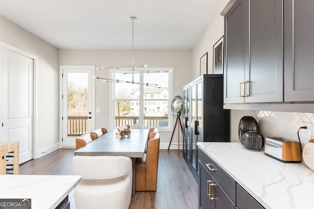 dining area featuring baseboards and wood finished floors