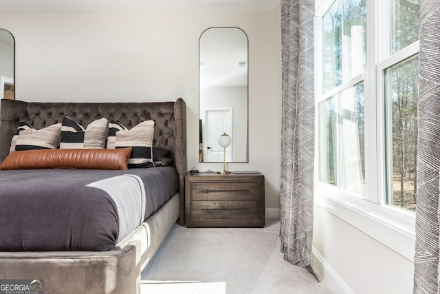 bedroom featuring baseboards, multiple windows, and carpet flooring