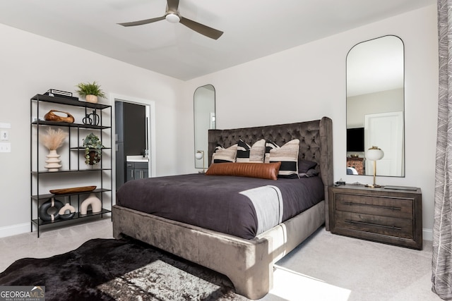 bedroom with arched walkways, carpet flooring, baseboards, and ensuite bathroom