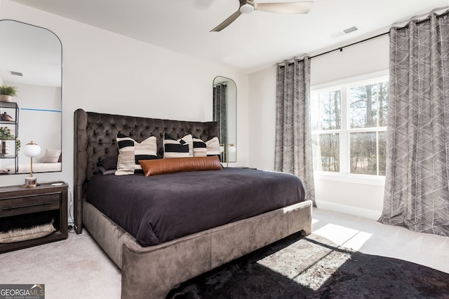 carpeted bedroom with visible vents and ceiling fan