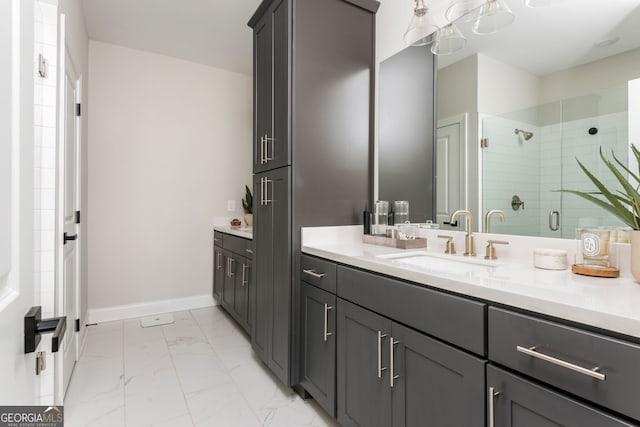 bathroom featuring baseboards, a stall shower, vanity, and marble finish floor