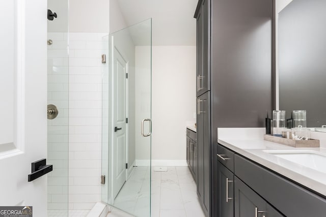 bathroom with vanity, marble finish floor, a stall shower, and baseboards