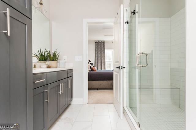 bathroom featuring ensuite bath, a shower stall, marble finish floor, vanity, and baseboards