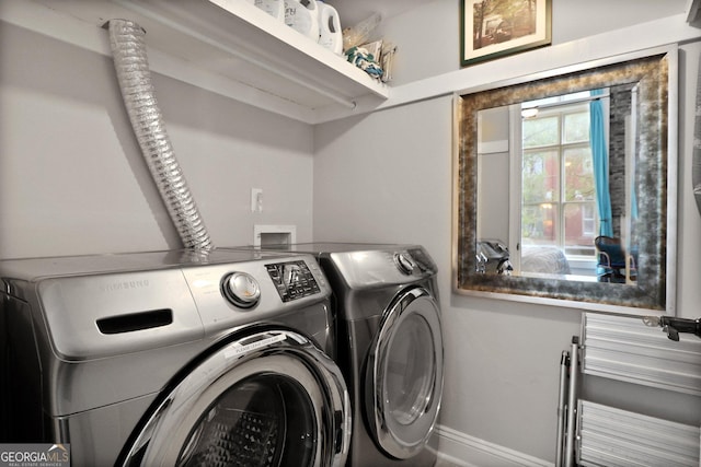 110 Barnard St, Savannah, GA 31401 - laundry room with baseboards, laundry area, and washing machine and dryer