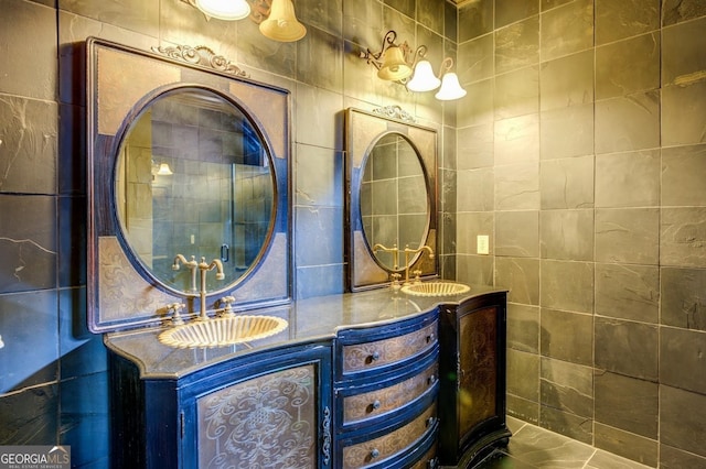 full bath featuring tile walls, a sink, and double vanity