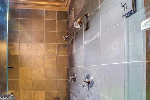 interior details with crown molding and tiled shower
