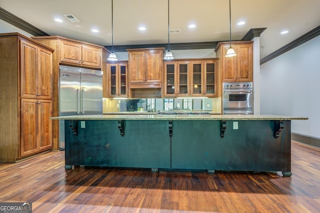 kitchen with a kitchen breakfast bar, visible vents, light stone counters, and crown molding