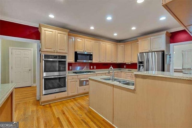 kitchen featuring a warming drawer, a sink, stainless steel appliances, and light countertops