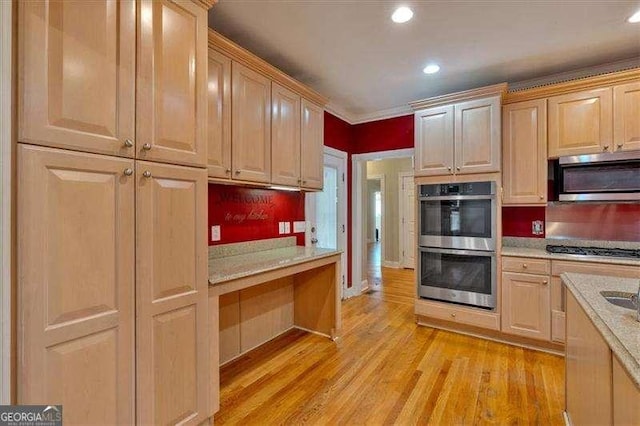 kitchen featuring recessed lighting, light brown cabinets, appliances with stainless steel finishes, and light wood-style flooring