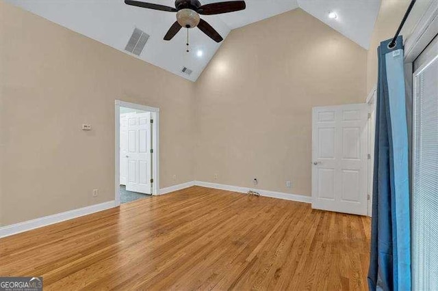 unfurnished room featuring visible vents, high vaulted ceiling, ceiling fan, and light wood-style flooring
