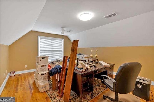 office with lofted ceiling, visible vents, wood finished floors, and baseboards