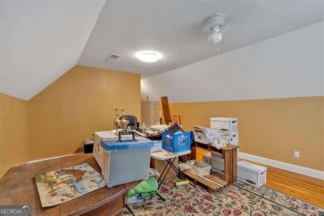 bonus room with visible vents, vaulted ceiling, wood finished floors, and baseboards