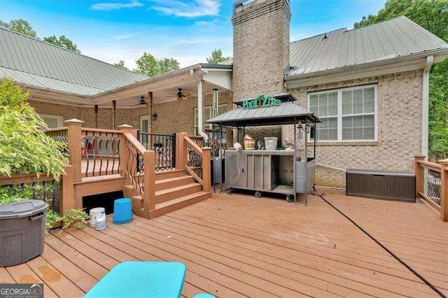 wooden deck featuring a gazebo and a ceiling fan