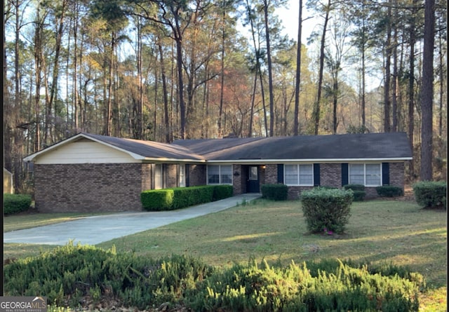 ranch-style house with concrete driveway, a front yard, and brick siding