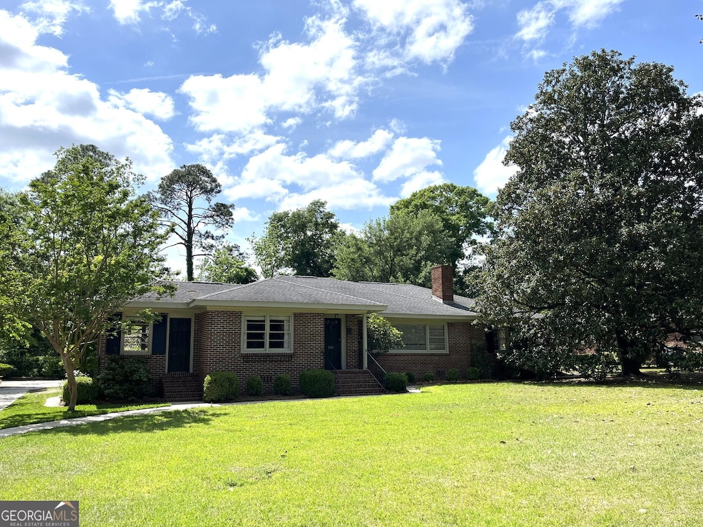 106 Zenith St, Dublin, GA 31021 - ranch-style house featuring a front yard, a chimney, and brick siding