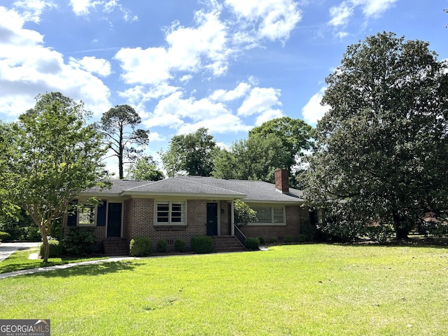 106 Zenith St, Dublin, GA 31021 - ranch-style house featuring a front yard, a chimney, and brick siding
