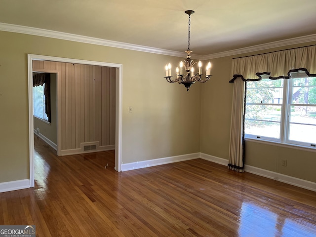 106 Zenith St, Dublin, GA 31021 - spare room featuring crown molding, visible vents, baseboards, wood finished floors, and a notable chandelier