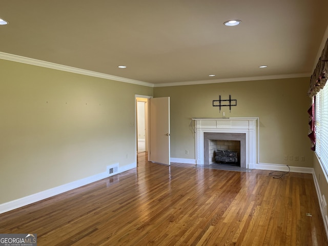106 Zenith St, Dublin, GA 31021 - unfurnished living room featuring recessed lighting, wood finished floors, baseboards, visible vents, and a fireplace with flush hearth
