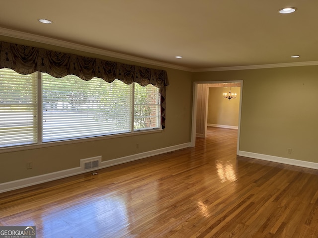 106 Zenith St, Dublin, GA 31021 - interior space with wood finished floors, a chandelier, ornamental molding, baseboards, and visible vents