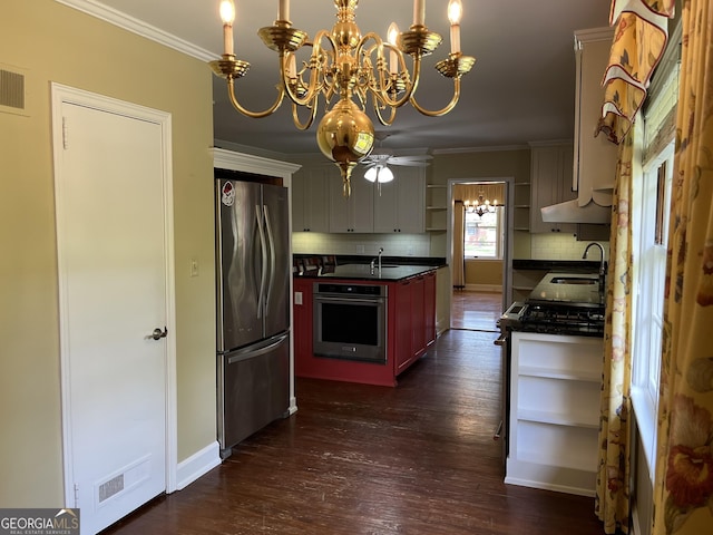 106 Zenith St, Dublin, GA 31021 - kitchen with an inviting chandelier, stainless steel appliances, open shelves, crown molding, and dark countertops