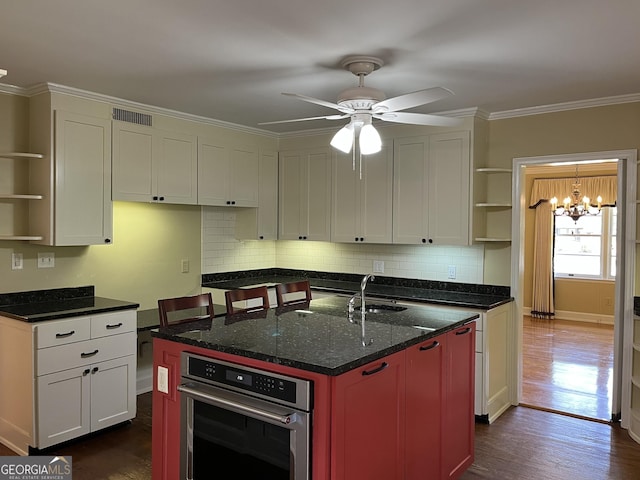 106 Zenith St, Dublin, GA 31021 - kitchen with dark wood-style floors, a sink, open shelves, oven, and ornamental molding