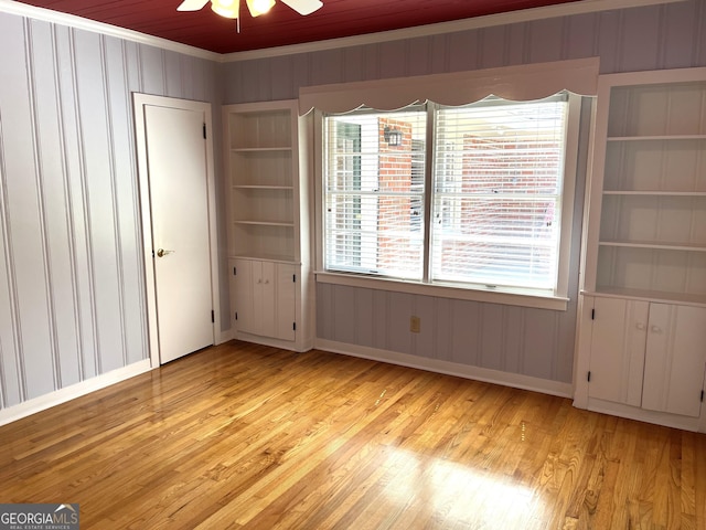 106 Zenith St, Dublin, GA 31021 - unfurnished bedroom with wooden walls, ornamental molding, light wood-style floors, and multiple windows