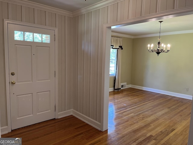 106 Zenith St, Dublin, GA 31021 - entrance foyer featuring ornamental molding, wood finished floors, visible vents, and a chandelier