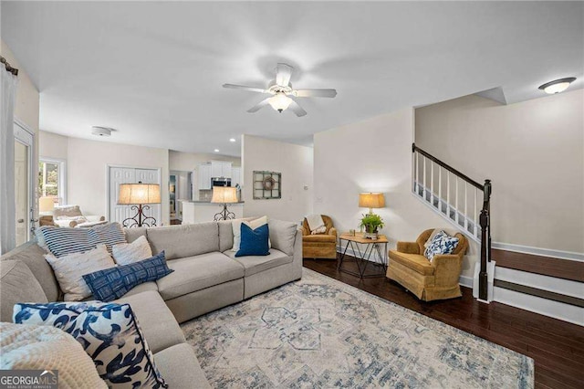 9310 Old Preserve Trl, Ball Ground, GA 30107 - living area featuring wood finished floors, a ceiling fan, and stairs
