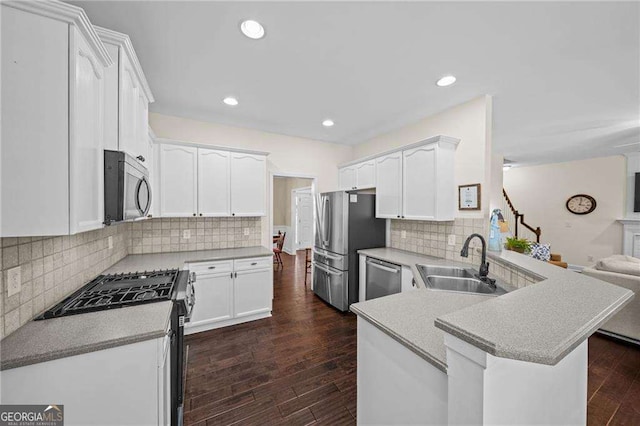 9310 Old Preserve Trl, Ball Ground, GA 30107 - kitchen with stainless steel appliances, a peninsula, open floor plan, white cabinets, and recessed lighting