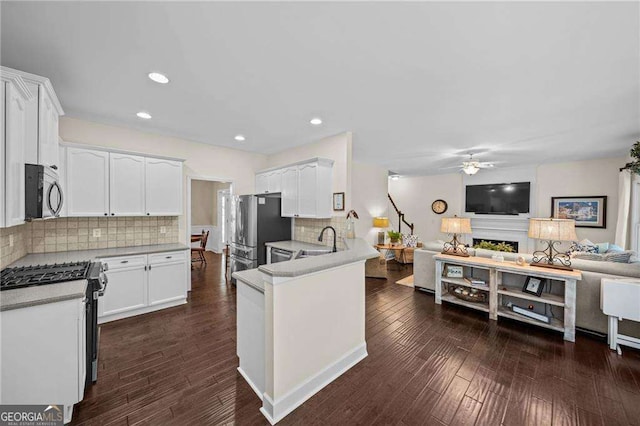 9310 Old Preserve Trl, Ball Ground, GA 30107 - kitchen featuring a ceiling fan, open floor plan, appliances with stainless steel finishes, and white cabinets