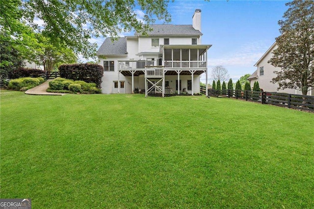 9310 Old Preserve Trl, Ball Ground, GA 30107 - back of property featuring a sunroom, a chimney, a deck, and roof with shingles