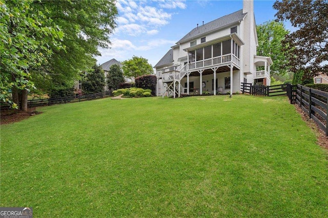 9310 Old Preserve Trl, Ball Ground, GA 30107 - back of property featuring a lawn, a fenced backyard, stairs, and a sunroom