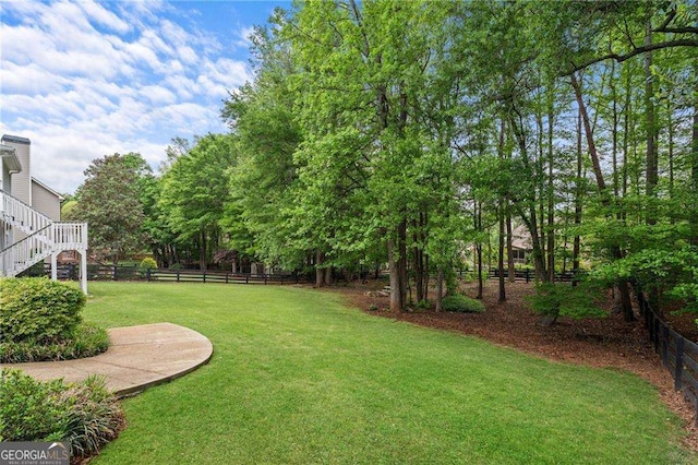 9310 Old Preserve Trl, Ball Ground, GA 30107 - view of yard with a fenced backyard and stairs