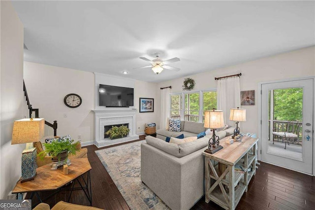 9310 Old Preserve Trl, Ball Ground, GA 30107 - living room featuring baseboards, ceiling fan, a brick fireplace, and dark wood-style flooring