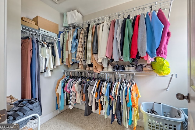 walk in closet with carpet flooring