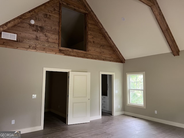 135 Church St, Palmetto, GA 30268 - unfurnished bedroom with visible vents, baseboards, beam ceiling, wood finished floors, and high vaulted ceiling