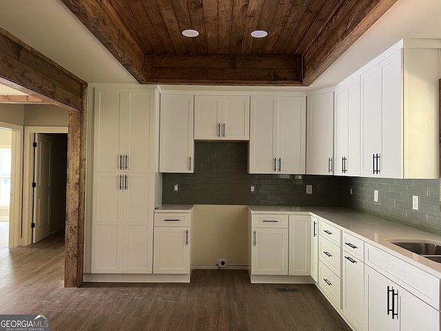 135 Church St, Palmetto, GA 30268 - kitchen with wood ceiling, dark wood finished floors, white cabinets, and decorative backsplash