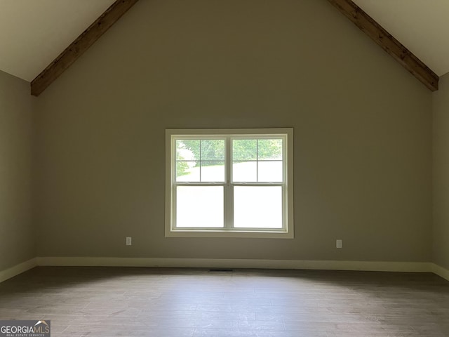 135 Church St, Palmetto, GA 30268 - spare room with beam ceiling, high vaulted ceiling, wood finished floors, and baseboards