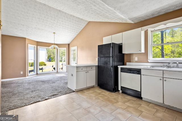 kitchen featuring a sink, light countertops, white dishwasher, freestanding refrigerator, and light carpet