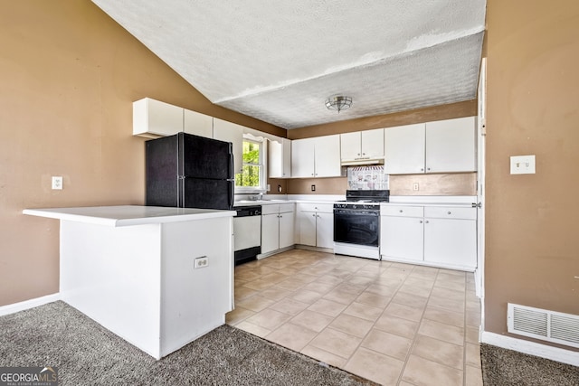 kitchen with freestanding refrigerator, gas range oven, white cabinetry, visible vents, and dishwashing machine