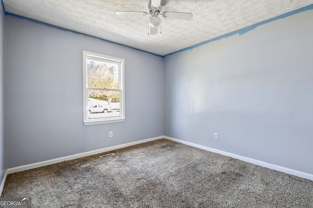 carpeted spare room featuring baseboards, visible vents, a ceiling fan, and a textured ceiling