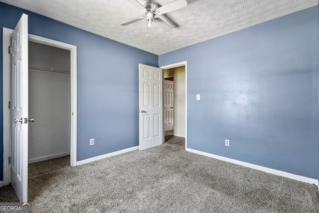 unfurnished bedroom featuring a closet, carpet, baseboards, a ceiling fan, and a textured ceiling