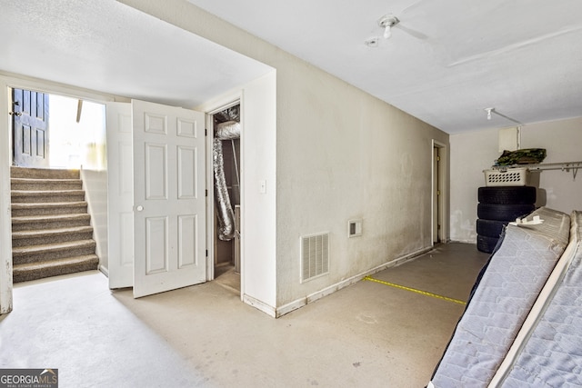 interior space featuring stairs, visible vents, and baseboards